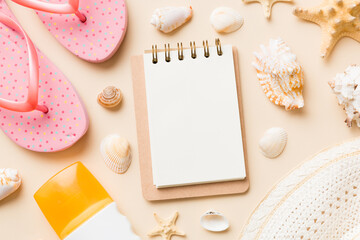 Blank writing book with summer beach accessories on background, copy space. Flat lay with copy space