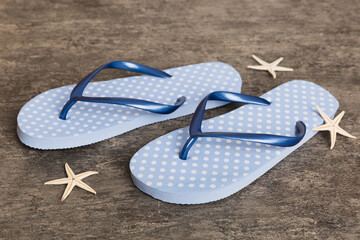 Beach accessories. Flip flops and starfish on colored background. Top view Mock up with copy space