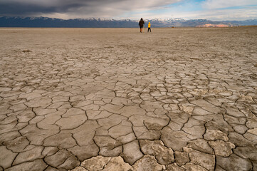 father and son walking in a dry lake bed in antelope island Utah