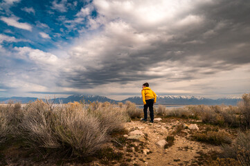 a curious boy looking at the view at antelope island in Utah