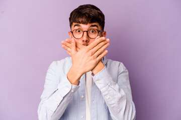 Young caucasian man isolated on purple background shocked covering mouth with hands.