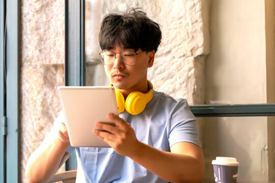 Asian teleworking while having a coffee