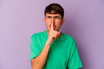 Young caucasian man isolated on purple background keeping a secret or asking for silence.