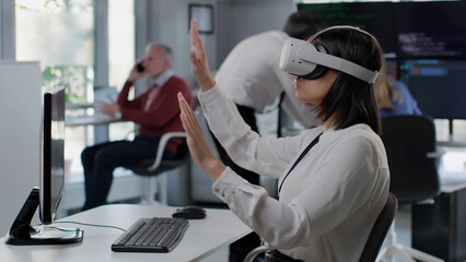 African-American female using futuristic augmented reality software interface for managing business 