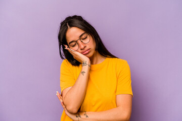 Young hispanic woman isolated on purple background who is bored, fatigued and need a relax day.