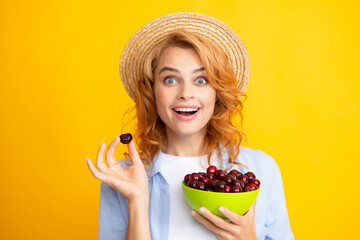 Young stylish woman isolated holding red colorful cherries. Berries harvest season. Summer diet...