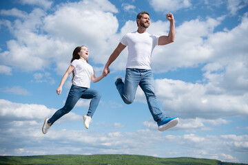 Fototapeta na wymiar happy father and daughter jump in sky. friendship