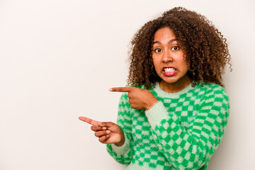 Young African American woman isolated on white background shocked pointing with index fingers to a copy space.