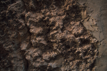 Brown wall texture. Stone background. Rock texture. Grunge Rough structure. Abstract texture. Rock surface with cracks. Rock pile. Paint spots.