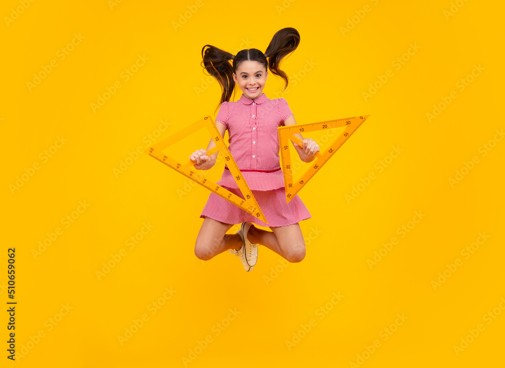 Poster back to school. school girl hold ruler measuring isolated on yellow background. crazy jump, jumping 