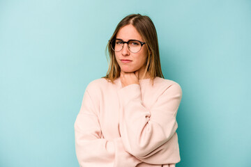 Young caucasian woman isolated on blue background suffers pain in throat due a virus or infection.