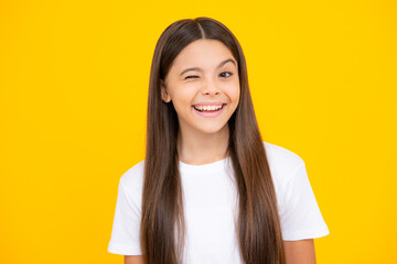 Funny face. Teenager child girl close one eye, winks and smiling. Human facial emotions concept....