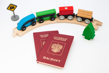 Russian passport on a white background with and toy railroad