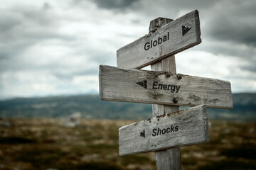 global energy shocks text quote on wooden signpost outdoors in nature. Inflation, economy and finance concept.