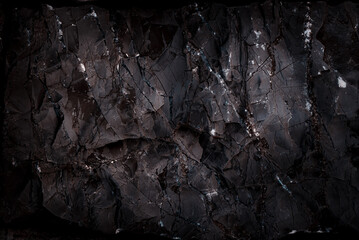 Grunge Rough structure. Black texture. Stone background. Dark marble. Rock texture. Rock surface with cracks. Rock pile. Paint spots wall. Abstract texture.