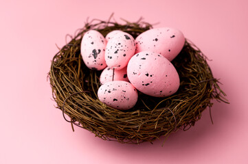 Fototapeta na wymiar Closeup of Pink eggs in the nest on pink background .