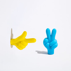 Bright yellow pointer and blue Peace or Victory symbol icon on white background.  Make peace not war concept.