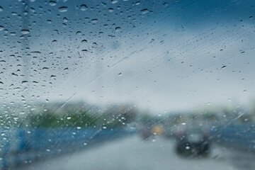 Raindrops falling on glass, abstract blurs - monsoon stock image of Kolkata (formerly Calcutta) city , West Bengal, India