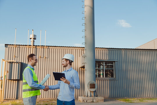 The customer greets civil engineer with a handshake at mini thermal power plant