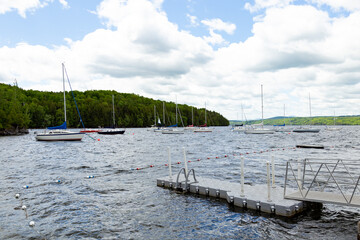 Sailboats moored in Lake Memphremagog in the Estrie region during a spring morning, Magog, Quebec, Canada
