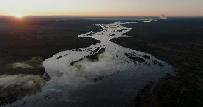 High aerial sunrise view of the mighty Zambezi River flowing down to the Victoria Falls, Unesco world heritage site