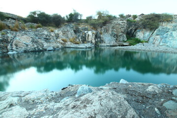 the place is beautiful , with mountains, rocks , small fish