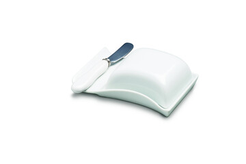 White porcelain butter dish, closed, with butter knife by the side, isolated on white