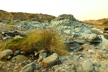 the place is beautiful , with mountains, rocks , small fish