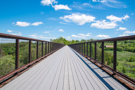 Doube's Trestle Bridge, an old railway bridge that has since been converted into a hiking path, extends across a lush green valley near Peterborough, Ontario.