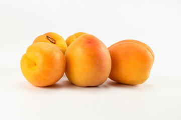 A group of apricot fruit isolated on bright background. Close up view.