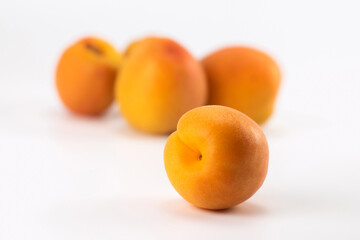 Fresh apricots on bright background. Selective focus.