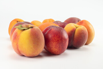 Fototapeta na wymiar Peaches, nectarines and apricots on bright background. Close up view.