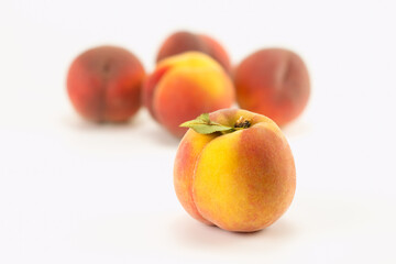 Fresh peaches on bright background. Selective focus.