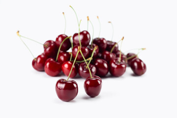 Obraz na płótnie Canvas Fresh cherry fruit isolated on bright background. Selective focus.