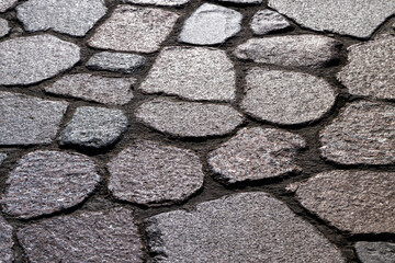 a road made of stones and cobblestones in the old style