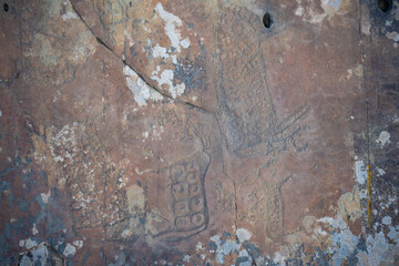 Drawn figures on the stone wall. Rock painting in mountain of Altai Republic, Russia
