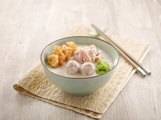 Duo Combination Chicken Meatball Congee served in a dish isolated on mat side view on grey background