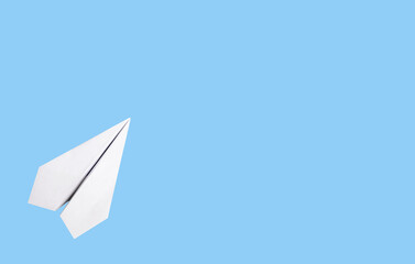Banner with white origami plane on blue background. Symbol of starting all over. Place for text. High quality photo