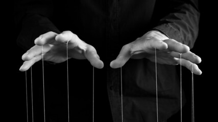 Man hands with strings on fingers. Violence, harassment, bullying concept. Master, abuser using...