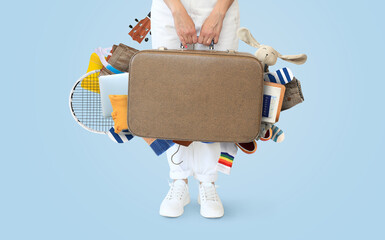 Travel concept. Girl hold a large suitcase and other accessories
