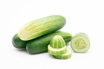 whole cucumber with some pieces isolated on white background.fresh vegetable for healthy diet.