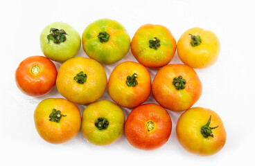 Group of different types of tomatoes over on white background. Top view.Ripe tomato