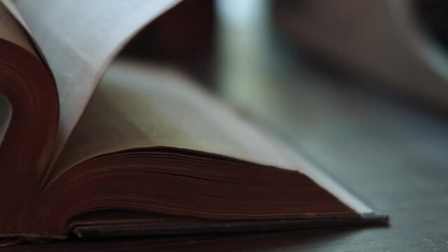 Browse pages of old book falling little by little.
