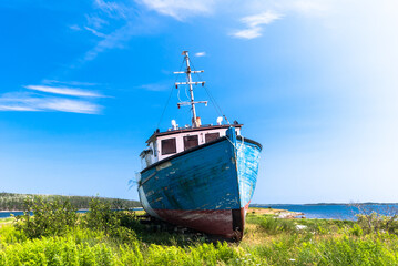Landscape with an old wooden fishing boat on the ground, Nova Scotia, Canada.