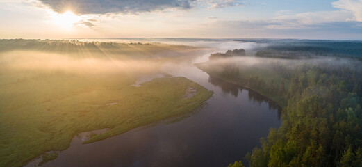 Aerial panoramic landscape with sunset over the river and beautiful clouds on the sky.
