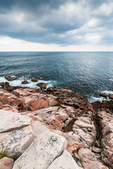 Rocky coast of Cape Breton Highlands, Nova Scotia, Canada, vertical.