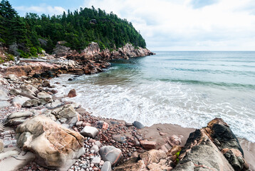 Cobblestone and rocky shoreline on Black Brook beach, Cape Breton Highlands Nova Scotia, Canada.