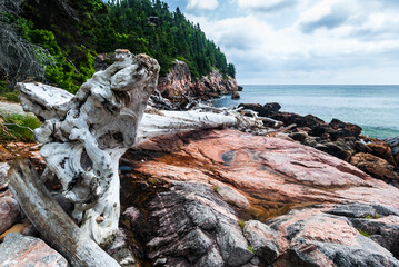 Cobblestone and rocky shoreline on Black Brook beach, Cape Breton Highlands Nova Scotia, Canada.