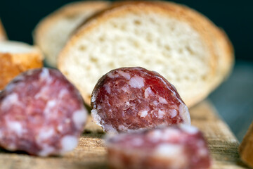 sausage sliced with a baguette on a wooden board