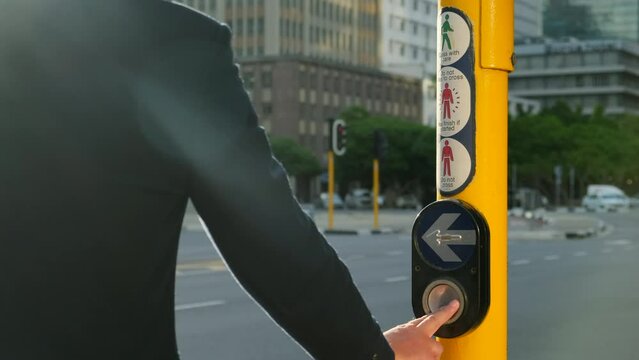 Crosswalk pedestrian signal button and sign to switch traffic. Traffic rules and regulations for public safety in USA. close-up finger presses a button on a traffic light at a pedestrian crossing